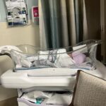 Iliza Shlesinger Instagram - Postpartum done right. I didn’t stop eating from the moment I had him until we left the hospital. ➡️ swipe to the end to see the @haveacornchips I accidentally dropped into his bassinet as I stood over him power eating and staring at my sweet little boy. It got wedged between the plastic and the mattress 🤷‍♀️ Hope he likes salty corn milk! 🧂 🌽 🥛 💦 the @yeti I just realized was there but YETI deserves a shoutout because the good ice they gave me at the hospital stayed AS ICE even after I got home. Best part is I’ve had it for years and it doesn’t give me lead poisoning. Bring it to your next delivery!