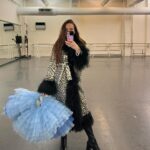 Isabella Boylston Instagram - A day in the life of a purple unitard 💜 Coat is @charlottesimone 🐾