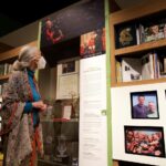 Jane Goodall Instagram – Happy International Museum Day! 📚🏛️🔍 At the Jane Goodall Institute, we’re so proud to collaborate with these centers of learning and culture, especially through our own traveling #BecomingJane exhibition with @insidenatgeo !
“Becoming Jane: The Evolution of Dr. Jane Goodall” follows Jane’s journey from a young woman who dreamed of living with wild animals, to the global icon we know today. Take a step inside a recreation of Jane’s research camp in Gombe, Tanzania, learn about the research that has continued since these early days, and hear from a hologram-like projection of Dr. Goodall as she shares her memories from that extraordinary time.
Have you explored the exhibition yet? Now’s the last chance for folks in #SaltLakeCity, UT to see it at @nhmu before it departs on May 28. But not to worry — the adventure continues at @thedurhammuseum in #Omaha, NE where the exhibition will be opening on June 22! Learn more — LINKS IN BIO
📸 credit: Jonathan Orr
…..
#museumday #museums #education #thingstodoinsaltlakecity #thingstodoinomaha #exhibition #janegoodall #janegoodallinstitute #chimpanzees #conservation #nonprofit #chimpanzeeconservation #interconnected #communityledconservation #communityconservation #wildlife #africanwildlife #tacare
Alt text:
A photo of an elderly, feminine person with pale skin and white hair pulled into a ponytail (Dr. Jane Goodall) participating in an interactive display, a part of the exhibit aimed at recreating one of her iconic photos. She is leaning her head down to touch the fingertips on a metal sculpture of a chimpanzee arm reaching out. Behind and to the right of her is the famous photograph in question—a younger Jane similarly posed but her head touched by a real chimpanzee in Gombe.
A photo of an elderly, feminine person with pale skin and white hair pulled into a ponytail (Dr. Jane Goodall) looking up at a museum display showcasing photos from her life, awards she has won, books, art, and more.
A photo of an elderly, feminine person with pale skin and white hair pulled into a ponytail (Dr. Jane Goodall) looking at a glass case with a green platform inside, and a telescope resting on the platform.