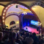 Jane Goodall Instagram - “If you’ve heard this story before, well that’s too bad,” Dr. Jane Goodall said with a twinkle in her eye to a packed auditorium at Seattle’s Moore Theater. Dr. Goodall went on to explain that in indigenous American tribes, stories are often told over and over again, becoming a source of comfort and familiar knowledge. She expressed her appreciation for this tradition and joked that if anyone in the audience didn’t like it, “too bad,” as she would be sharing her familiar stories tonight and throughout her tour — she’s currently traveling the world in celebration of her 90th birthday. As Jane tells us, stories create a sense of community and connection to each other. This humorous anecdote from Jane was a powerful reminder that stories have the ability to transcend time and culture, bringing people together and providing comfort and inspiration. Did you catch Jane live in Seattle, at the Beacon Theater in NYC, or at another tour event? Share your favorite stories in our comment section so we can connect within our own JGI community! 📷 Alyssa Rasp/MSGE, Jim Bennett, JGI/Sylvie Alt Text Slide 1: Jane speaking to the packed auditorium of the Beacon Theater in NYC. Slide 2: Jane jogging a few steps out onto the stage towards the podium where Mr. H, her stuffed monkey companion, is already placed. Slide 3: Photo of the marquee of the Moore Theater in Seattle with Jane Goodall presented. Underneath, there is a long line of audience members awaiting entrance to the theater that is wrapped around the building. Slide 4: A photo of a birthday edition Mr. H (holding a birthday cake instead of his usual yellow banana) in front of the stage at the Moore Theater. Slide 5: A photo of a packed house in the Moore Theater with Jane speaking onstage. @beacontheatre @stgpresents #JaneAt90 #JaneGoodall #JaneGoodallInstitute #ConservationHeroes #Birthday #90thBirthday #Conservation #CommunityConservation #Volunteer #Activism #TakeBoldAction #BoldAction #Hope #HopeIntoAction
