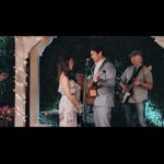 Jessica Lowndes Instagram - I wrote and produced this heartwarming film “Over The Moon in Love” (and composed all the music) initially for @hallmarkchannel and it’s now available on @amazonprime, @appletv, @googleplay and the @hallmarkmoviesnow app! 🌙 We filmed it in Vancouver (where I’m originally from) so I had the joy of featuring my Dad and Uncle as extras!!! 😂 SWIPE to the end for a glimpse of my Dad, portraying the “drummer” despite never having held drumsticks in his life. 🥁 Little did I anticipate having to film a kissing scene right in front of him! Clearly didn’t think that one through (should’ve made him the janitor 😅🤣) My Uncle’s expression in the top right-hand corner of the last photo cracks me up! 😂 Our theme song “Paradise” made it to #1 on the iTunes singer songwriter charts 🤯 and is available anywhere you stream music!