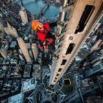 Jimmy Chin Instagram - The shot. Getting the shot. The 408-foot spire on top of One World Trade Center brings the height of the building to 1776 feet, making it one of the tallest man-made points in the Western Hemisphere. It's also possibly the best climb in NYC. Lots of exposure, 360-degree views of Manhattan, and easy 5.5 jugs to the highest point in the city. Certainly a classic route, but access can be a bit tricky.... From a @nytmag cover shoot a while back. Zoom in on the second shot... Second photo by @geosteinmetz