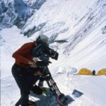 Jimmy Chin Instagram - Deeply saddened to hear about the passing of David Breashears this week. He was a friend and mentor and had an outsized influence on many peoples’ lives, including mine. I looked up to him long before I met him. His endeavors as an incredibly bold climber and world class mountaineer were legendary. He was also a human rights advocate, spokesperson for climate issues and someone I considered to be the greatest mountain filmmaker of our time. Among many notable films, David’s Everest IMAX film would become the highest grossing IMAX film of all time. It was a cultural phenomena for an entire generation. In 2004, David invited me to climb Everest and film with him, @edviesturs, Veikka Gustaffson and Robert Schauer. I was a long shot candidate to fill the role he was proposing. I was young and had just started filming the year before. It was a pivotal moment in my career. David was intimidating and opinionated but deeply caring and had a razor sharp wit. He was brilliant and, some would say, complex. His exacting standards and high expectations pushed me to rise to a new and much higher level both as a mountaineer and as a cinematographer. We eventually climbed Everest together that year and became close friends. I learned a lot on that expedition. He taught me how to approach a major production on a big expedition and the attitude and ethos required to pull off a challenging project in good style. These were lessons I’ve carried with me throughout my career. I am forever grateful that he believed in me and for my time with him. Here are a few images from the 2004 expedition including one of my favorite post Everest summit bad hair day images. Rest In Peace my friend. You will be dearly missed.