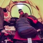 Jimmy Chin Instagram - Tent life with @conrad_anker and @brady_robinson. During the first week of our 2001 expedition to K7, Brady and I noticed that Conrad always got up before us. We didn't want to seem lazy, so we started getting up earlier and earlier every morning. But each day, Conrad was making coffee or organizing gear by the time we were out of our tents. The night before attempting K7, the three of us agreed to wake up at 3 a.m. Brady and I secretly decided to wake up at 2 a.m. to get ready before Conrad. That morning, Brady and I woke early, quietly gathered our gear, and exited our tent in the dark. As we rushed to load our packs, a headlamp clicked on nearby. I looked over to see Conrad leaning casually against a rock with his pack shouldered and ready to go. I shook my head in awe and disbelief. @thenorthface