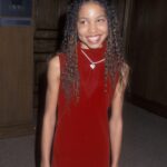 Jurnee Smollett Instagram – Yo…S/o to my mom for letting me rock this crushed velvet red dress to the premiere of #evesbayou back n the day…11 year old Jurnee thought she was so fly 😜 y’all ever have that one outfit as a kid you felt super duper fly in? And then look back and be like yo I would rock that today! 🤣🤣 #tbt