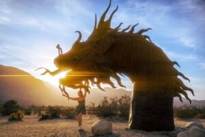 Katrina Law Instagram - MOTHER OF DRAGONS - Katrina Law poses with a dragon in the desert…the setting sun a fiery pearl of light in its mouth. Timing is everything. HAPPY YEAR OF THE DRAGON TO EVERYONE!!!