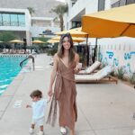 Kayla Ewell Instagram – The end of Summer & the beginning of my Birthday. ☀️ 

Sometimes you pack up the fam & take a last minute trip to Palm Springs right before school & a giant storm start. 

Family time is my favorite time. The 
kids loved every minute, including the car ride home. (We timed it perfectly & they slept the whole way home, little do they know that was the best present they could give.) 

•Dress & shoes are @zara 
•Jones’ trunks & oufit @zarakids 
•Onesie is our favorite @kytebaby 
•Bikini is @allsaints from a few years back & it’s still one of my favorites