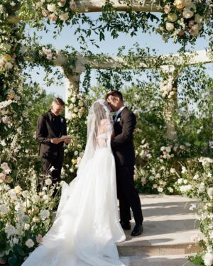 Kirstin Maldonado Instagram - Still reeling and playing catch up from literally the best day of my life. To be surrounded by all our loved ones, family and friends, that came and journeyed to Texas to be with us was a dream come true … and speaking OF! SO WAS THIS HELL OF A PARTY!!

To @orangeblossomspecialevents, to ALL our vendors, thank you thank you thank you for making this important day so incredibly special, for listening to me when I say “I think the flowers should be neutral but look like golden hour is touching them,” (WHICH @bowsandarrowsflowers NAILED) to incorporating all things that are special to @hausdo and me (our dogs, little EDC moment, etc), and to be willing to collaborate and bring in your own expertise to make this truly the most fun and exciting thing to plan ever!!! Ben and I are having withdrawals from how perfect everything was and from all those memories shared with our favorite people in the world 🥹🥹

It was truly an honor to have all of you a part of my wedding. I am such a big fan of your work, your attention to detail, and your artistry. 

And speaking of artistry - these photos!? @dueyphoto is an absolute queen. So timeless. So romantic. I can’t wait to see the rest and you know I truly fangirl. But I feel this about all of you guys listed below 🥹

This was so much fcking fun ❤️ THANK YOU!! IM A WIFE!!! LETSSS GOOOOO~

Planning @orangeblossomspecialevents 
Photo @dueyphoto 
Video @31films
Florals @bowsandarrowsflowers
Stationary   Wedding Weekend Paper Gorgeousness @inquisited
Bridal Glam @samiknighthair @anthonyhnguyenmakeup 
Dress @kimkassascouture @jaxonjamescouturebridal 
Nails @amirasallure
Wedding Bands   Jewelry @icerock_diamonds 
Wedding Prep @detoxbyrebecca @ontheglowtansdfw
Venue @dvinegracevineyard
First Dance @sleepingatlast 
Band @drywaterband
Wedding Party Glam @lipservicemakeup
Feature @people
Rentals @bellaacento @poshcouturerentals @marquee_rents
Cake @fancycakesbylauren
Fireworks @illuminationfireworks
Dress Prep @etoillyatelier