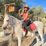 Lana Parrilla Instagram - After 17yrs, I decided to finally come back to the Sierra Nevada Mountains to ride with the best horseman in all of España at the @caballos_la_querencia campo 🐴 🇪🇸 I met my dear friend Fernando Reyero in the summer of 2006 when I decided to move to Spain to study Spanish and brush up on my horseback riding skills 3x a week for nearly 5 months. And where better than the Andalucia in España, right! Granada, Spain became one of my most favorite cities in the world. As someone who’s Spanish speaking skills were poor, you can imagine how intimidating it was to move to a foreign country, not knowing anyone and trying to connect with people who don’t speak your language. Luckily for me, I met one person who really helped me feel welcomed. I was immediately embraced by Fernando who’s English is perfect. He’s not only an incredible teacher and horseman, he’s a wonderful writer and a study of multiple languages. So when I arrived, he greeted me in English, Spanish and French and said, “Which do you prefer?” I replied, “English for now.” 🫣 If you’re looking for adventure on horseback in one of the most stunning places in the world, look no further. Fernando has the most beautiful horses & pups that will melt your heart upon meeting them. He’s created such a wonderful family with these animals and they will all go with you on the journey up the mountain and wait for you while you cool off with a refreshing drink & tapas while overlooking the impressive views of the Sierra Nevadas. This magical experience will keep you smiling for days! For the past 17yrs I’ve wanted to live in this part of Spain. I’ve honestly never been happier. Living with just my basic needs, surrounded by beautiful people, food and culture. And since this trip, I feel like I’m getting closer to that dream. Yay! Who knows, maybe we’ll end up riding together one day! 🤞 Plz go to @caballos_la_querencia for more information on how to have to the adventure of a lifetime. And please make sure to give Fernando a big hug for me! ❤️🇪🇸🐴🍻 #adventure #españa #horsebackriding #andalucia #spain #horses #riding #caballos #friendship #supportsmallbusiness #happiness #caballoslaquerencia #potd