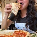 Lana Parrilla Instagram - Mangiare mangiare! Is literally all I want to do when in Napoli! All the smells of street food everywhere you go is so highly intoxicating and iniquitously tempting! Universally, Napoli has some of the greatest food and I was literally put in a time machine back to my grandmothers dinner table yesterday tasting everything! A proud Sicilian!!! Yes Neapolitans and Sicilians are the same! 🤝 Naples also happens to be the pizza capital of the world. So I HAD to come here to learn HOW to make their traditionally moist, perfectly thin dough pizza. And who better than Luigi Marra to guide me at his famous restaurant @san_carlo_17 🍕 What a blast! Btw, making pizza is much more challenging art than I thought. Not only do you have to get the measurements right, and how much to use when, you have to know temperatures, inside the oven and outside the oven. The temperature of the air, the water, my fingers and my palms all have an impact on the dough. I felt like I was in a pizza chemistry class. 🤓🍕📖 Chef Luigi is an excellent teacher with a wonderful sense of humour and an enormous amount of patience. He’s extremely knowledgeable, a professor of the craft and reminded me of how crappy my math skills were when he started adding up the amount of grams per ingredient 😵‍💫 It truly was such a pleasure to learn the secrets behind making a Neapolitan pizza by the master himself! Respect ✊🏽 Grazie mille Luigi! 💋🇮🇹🍕❤️ If anyone is looking for a cool experience while in Naples, don’t miss out on this one! ⭐️ #italy #neapolitan #pizza #cookingclass #naples #newskills #mangiare #italian #dna #foodie #potd