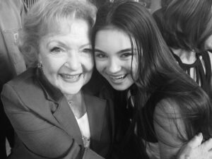 Landry Bender Instagram - In 2014 I worked with a 2nd AD who overheard me gushing to some crew members about how much I loved Betty and her spirit, longevity, and whip smart comedic timing. She came up to my mom and me at the end of the day and told us she worked on Hot in Cleveland and asked if we wanted to come to a taping to meet her. We went, and it was the only time in my life I’ve ever been star struck. She told me she liked my dress and I just stared back in awe, this photo is still framed in my bedroom to this day. The world suddenly feels so heavy today. RIP Betty. Thank you for inspiring me and adding so much joy into all of our lives ♥️