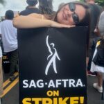 Landry Bender Instagram - I strike for the 10 year old me that joined the union and the 80 year old me that hopes to still be working. The majority of @sagaftra member’s job is simply AUDITIONING for the next job - and the majority of members don’t qualify for health insurance. (please consider donating to @sagaftrafound!) We marched this morning for unions in every field - we need fair wages and contracts. My favorite quote today from @msjoelyfisher: “What you are doing right now is bigger than any role you’ll ever play.” 🪧 #sagaftrastrong #unionstrong