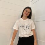Landry Bender Instagram - I am SO honored to join @citizensofhumanity in supporting @girlsincla, whose interactive programming provides girls from under-resourced communities with the tools and support to be STRONG, SMART & BOLD ❤️‍🔥 They have joined forces with a collective of female creatives to design limited edition t-shirts with original artwork in hopes to visually inspire others to empower the next generation of women. I am proudly wearing my tee designed by the incredibly talented Carly Kuhn of @TheCartorialist.   The tees are available exclusively on citizensofhumanity.com with 100% of the retail price of every tee sold from the collection donated towards @girlsincla!!!