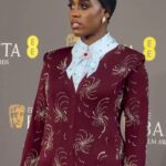 Lashana Lynch Instagram - Thank you @prada for this delicious custom look for @bafta last night. The baby hairs were proud to live in this moment, too! 💁🏾