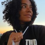 Lauren Ridloff Instagram - It’s been a big week. Heck, a big month. This is me right now, literally just seconds ago, standing on the balcony watching the sun set. That’s all.