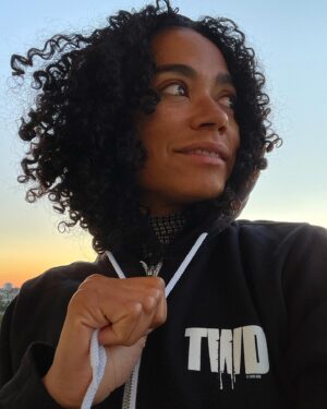 Lauren Ridloff Instagram - It’s been a big week. Heck, a big month. This is me right now, literally just seconds ago, standing on the balcony watching the sun set. That’s all.