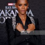Letitia Wright Instagram - incredibly grateful to the team at @alexandermcqueen & @shionat for this custom design for the World Premiere of @blackpanther #wakandaforever 11.11 Jewellery by @cartier 📸 by @nishajohny & @jonathanjacobs_