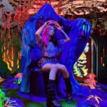 Lexi Brumback Instagram - Story time: I remember back in the 2018/2019 school year, watching a YouTube video about a weird wonderland called MeowWolf based in Santa Fe NM…and just thinking “wow I NEED to go here” as I’ve always been obsessed with Alice in Wonderland. After finishing my first year at Navarro College *before the show aired and my life got crazy* I made plans with a couple friends to road-trip 13 hours to NM with $200 to my name. Yes we stayed in the most repugnant motel Santa Fe had to offer bc that’s all we could afford, but I will never forget the creative inspiration and child-like wonder that visiting MeowWolf gave to me in the few hours we were exploring it. Little did I know… that in 2021, MeowWolf would be inviting me personally as a creator to work with them when they opened their 2nd location in Las Vegas, and providing me with travel accommodations a few nights at the BELLAGIO (huge difference from mötel dōödòô that I stayed in for my first MW) To this day, that was one of my favorite life experiences and I seriously will cherish that memory forever. Now every time they open a new location, they invite me to get a first look into their new wonderland and it truly feeds my soul to have built this connection with a brand that inspires me so. I love you @meow__wolf 💖🐱🐺❤️‍🔥👁️👄❌✨ Also, don’t forget to check out their brand-new location, @meowwolfgrapevine which opens July 14th! It’s truly amazing and feels like all 3 of their other locations combined into 1!! . . . . . . . #sponsored #paidpartnership #inspiration #creative #art #lgbt #travel #bucketlist #wonderland #prideforever #artist #inspo