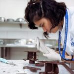 Louise delos Reyes Instagram - Intermediate Modern French Chef @ajie_segubiense gave us a challenge this week and decided to elevate our modern french cakes, essentially turning them into mini chocolate displays 🍫 Handling chocolate has never been an easy task for me coz, one, my hands are too warm for chocolate (hence the gloves). Second, if you are a clean freak like me you will end up wiping and washing your hands excessively 😂 But believe it or not, tempering chocolate at school relaxes me. So here's a little video of me doing sleighs and trains. All edible! @apca_philippines