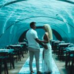 Lucie Donlan Instagram - Come with me to the Underwater restaurant in @hurawalhi 🌊 - Honestly this was by far the most incredible experience I’ve ever had. Luke treated me to this beautiful dining experience for my Birthday, and I was so emotional as this was the best meal, views and whole experience I’ve ever had in my life. The feeling of enjoying a luxury 5 course meal paired with wines in my favourite place in the world…the ocean💙 This memory will be in my heart forever, it was so special. I also loved dressing up for this occasion, a barefoot mermaid was the feeling so I’ve linked my outfit details below. 🐚 📍 @hurawalhi 🌊 Outfit details : White dress : @thegiftedsisters_ Jewellery : @sophiacjewelry Red dress : @ohpolly ( This is not it is not a tank or aquarium.) ❗️
