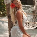 Lucie Donlan Instagram - The hibiscus flower 🌺 - a symbol of love, femininity, and happiness…🌺 What is your favourite flower? ⬇️ Dress : @thegiftedsisters_
