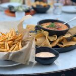 Lucy Davis Instagram - @graciasmadresocal The food here is just gorgeous. This is their Chipotle Garlic Fries, and Queso Fundidao (cashew cheese, jalapeño, pics de gallo and cilantro dip) Mouth watering😋