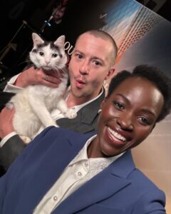Lupita Nyong'o Instagram - Schnitzel’s first junket?! Purrfection! 💯😽🎬 @josephquinn @aquietplace #DayOne