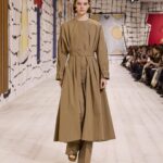 Maria Grazia Chiuri Instagram - The classic trench coat becomes the focal point of a fascinating #Dior Couture Spring-Summer 2024 stylistic exercise. Opening up the creative frontiers for this iconic item of Parisian chic, @MariaGraziaChiuri has totally rethought its archetypal aura by calling on the savoir-faire of the House's ateliers alike to cut cotton twill into belted dresses and voluminous outerwear.