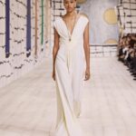 Maria Grazia Chiuri Instagram – With their ability to tame and transform textiles, shape silhouettes and control volumes, pleating and other forms of fabric manipulation play an important role throughout the new #DiorCouture Spring-Summer 2024 collection by @MariaGraziaChiuri. A white crêpe column exemplifies this type of #DiorSavoirFaire with its rows of precise pleats smocked to secure the positioning of the neckline and waist, while another draped dress is ingeniously gathered into a basketweave panel at the front. In red moiré faille, a pleated full skirt is paired with an update on the #DiorBarJacket to reinvent the original and peerless New Look icon.