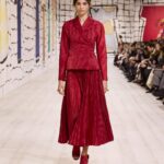 Maria Grazia Chiuri Instagram – With their ability to tame and transform textiles, shape silhouettes and control volumes, pleating and other forms of fabric manipulation play an important role throughout the new #DiorCouture Spring-Summer 2024 collection by @MariaGraziaChiuri. A white crêpe column exemplifies this type of #DiorSavoirFaire with its rows of precise pleats smocked to secure the positioning of the neckline and waist, while another draped dress is ingeniously gathered into a basketweave panel at the front. In red moiré faille, a pleated full skirt is paired with an update on the #DiorBarJacket to reinvent the original and peerless New Look icon.