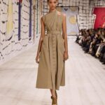 Maria Grazia Chiuri Instagram - The classic trench coat becomes the focal point of a fascinating #Dior Couture Spring-Summer 2024 stylistic exercise. Opening up the creative frontiers for this iconic item of Parisian chic, @MariaGraziaChiuri has totally rethought its archetypal aura by calling on the savoir-faire of the House's ateliers alike to cut cotton twill into belted dresses and voluminous outerwear.