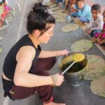 Marie Avgeropoulos Instagram - . Children need proper nutrition in the form of healthy, balanced meals each and every day, containing the vitamins and minerals needed to help maintain a healthy life. FFLV Ambassador Marie Avgeropoulos helps to serve the local families of Vrindavan during the food distribution program, which has been going on for the past 25 years. We also have three new limited edition items in our Bonfire shop. Proceeds benefit @fflvindia and its mission to end child marriage through education. Help make a difference. Link in bio to purchase our #SheMustCount collection. 💫