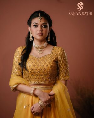 Masuma Rahman Nabila Instagram - @masumanabila In @safiya_sathi 

Whether it is an intimate wedding or a grand one, some brides truly know how to stand out and make a statement with their bold outfit choices. So today, we are embracing all those women who chose or want to choose the beautiful color yellow for their wedding day and simply looked like a million bucks. A new edition to House of Safiya Sathi's wedding couture, a traditional zardousi lehenga, with an exquisite classic cut that looks stunning in the color yellow. There is absolutely no doubt that pastels have been and will always be in fashion. No matter what event you have, or what time the event is, pastel yellow will look stunning if you pick the right shade. This time we opted for a beautiful pastel yellow in motka silk which brings a serene, subtle, and elegant touch to it.

In frame: Masuma Rahman Nabila
Photography: @salmikabir 
Makeup: Nidia Afroz
Jewellery: Dazzle by Sonia

#holudattire