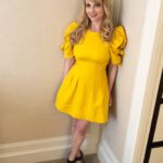 Melissa Rauch Instagram - Before I blast you with some more TBBT memories, here’s me today in my natural habitat...a corner. 💛 Styling: @kevinmichaelericson Hair: @matthewmonzon Makeup: @ktmell Dress: @seanewyork Shoes: @chloegosselin