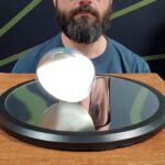 Michael Stevens Instagram - Euler's Disk: an amazingly simply physics toy. The heavy disk and low-friction mirror-surface allow spinning to last a looooong time. Look up my "Euler's Disk" video on the DING channel on YouTube to learn more! #physics #euler #disc #spinning #stemtoy #physicstoy #rolling