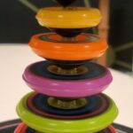 Michael Stevens Instagram - stacking tops #toy #physics #stem #stemtoy #physicstoy #gyroscope #balance #tops #spinning #stacking