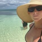 Michelle Leigh Calaway Instagram – I was simply enjoying a book on the beach when this “vegetation” looked a lot like a shark…..so I text hubby @undertaker 🦈😳kinda digging that last picture …A LOT😍#myprotector 🖤