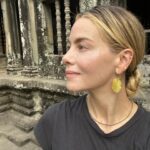 Michelle Monaghan Instagram - Lost in the magic of the ancient temples of Angkor Wat, aka “City of Temples”.✨This Eighth Wonder of the World is the largest religious monument in the world! Built 900 years ago, it holds the mythology of both Hindu and Buddhism religions. To experience its sheer beauty at sunrise was a dream come true. 💫Thank you to my incredible Cambodian tour guide “Lee” @chhvn1y_chhorn for the history lesson and for capturing our awe-inspiring day. I’ll treasure it forever. 🙏 #angkorwat #cambodia