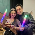 Ming-Na Wen Instagram - My husband is the most wonderful man. I am very lucky to have him, love him, and adore him. But this guy DOESN'T LISTEN! I told him I didn't want a surprise birthday party or a big party at all. I just want a quiet get together. He has gotten me many many times with surprise parties. I fall for it EVERYTIME!! So he said he would agree to my demands for no surprise party. He LIED!!!😡 On Oct 27th, we were going to #taylorswifterostourmovie. I was dressed in overalls with no makeup. Totally not prepared for what was about to happen. Obviously!! When everyone yelled "SURPRISE!"....it took me several seconds to register that it was for me. I couldn't believe it.🎂🎊🎂🎁🎂🥳🎊 Damn you, Eric! You got me again! It turned out to be a fun night, dancing in the theatre to #TaylorSwift (who's truly amazing! I consider myself a #swiftie now.) and eating cake with phallic decorations. At least I thought they were. 😏 Thank you to all my friends who participated in this great surprise and helping me celebrate my birthday early last month. It is such a blessing to have so much love and friendship. Even with a husband who doesn't listen and lies. He's a keeper! ❤️❤️🥰🥰❤️❤️❤️❤️❤️❤️❤️❤️ But that was only Part 1 of his diabolical plan for surprise birthday parties!