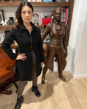 Ming-Na Wen Instagram - Like my twin?😂😂

Okay. Why do I have a LIFE-SIZE bronze statue of me as Fennec Shand? 

Well, my amazing husband started the process last April of having one made to celebrate my birthday.  It was carved from clay from just a photo as reference. The artistry and accuracy is remarkable. Several revisions took place. (Thank you, @mitchelwuphotography & @jenchiwu for your input.🥰) This was all done in secrecy. 

Unfortunately, it didn't arrive in time for my birthday last November. It just arrived last week. When we had a couples night with some of our dearest friends we've known for over 20 years, Eric unveiled it. What a tremendous surprise! We were all in awe!

He knows how much #starwars means to me; how being Fennec has been a childhood's dream come true for me. So he wanted to celebrate my birthday with something unique and BIG! He succeeded!!

At first, I was utterly astounded and amused. I also thought he was crazy! Where the hell were we going to put it? She couldn't be outside scaring people!

Once we moved her inside,  she actually fits great in our media room. She's home!
I love bronzed Fennec more and more, just like my love for this marvelous man. She's a daily reminder of how lucky I am to have such a thoughtful and loving husband. He's the best!  Thank you, babe! I love you, always. 
❤️🥰
#thisistheway #fennecshand #themandalorian #thebookofbobafett #starwars