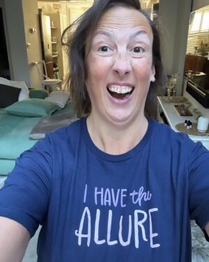 Miranda Hart Instagram - Sometimes, when my life and job involves posing in a t-shirt that states my ‘allure’ because it’s part of a comedy creation thingy I do, that can jar when you hold acute awareness of suffering in the same world. 
But I decided that the worst thing we can do is stop doing the things we do. Because not everyone can be on the frontline and we all have skills that the world needs and I suppose sometimes we just have to think about making our little patch of the world a fraction better for whatever silly or seemingly meaningless way. 
So here is me, my allure and my t-shirt from @themirandashop where I create some fun and cosy things that may help one or ten of you feel better. And remember you too have the allure!!! 🧡🧡
