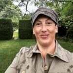 Miranda Hart Instagram – She’s smiling in the rain. 
She’s talking about herself in the third person. 
She’s wearing a new jacket that makes her feel like a cross between a gardener, a landgirl and Indiana Jones. 
 Important details of why I share here:-

British outerwear brand @TROYLondonUK has teamed up with @CountrysideFund by releasing a selection of their best-selling Tracker Jackets individually embroidered with The Prince’s Countryside Fund logo and donating £50 from each sale to the charity through the summer. These 100% cotton jackets are a great summer layer for those looking to support the vital work of the PCF to support farming businesses, rural enterprises, and provide training opportunities for young people.