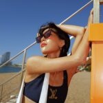 Molly Chiang Instagram - This LV beach ensemble captures my carefree, sun-kissed spirit amidst Barcelona‘s vibrant coastal allure. 🏖️🧡💙@#LVCRUISE25 @louisvuitton - 這趟的LV托特包 墨鏡禮物 立刻把它們帶來巴塞隆納海灘拍美照😆 搭配我在Capri購入的LV泳裝 是不是有點配！！！😝 海灘Look就完成🫶🏾 昨天起了個大早 跟麥力兩個人殺到巴塞隆納海邊拍這組照片 這個海灘是《Somorrostro beach》✨ 剛好離這次住的飯店只要大概10分鐘距離 然後我們大概也只花了10分鐘拍完這組（？）😂 你們不覺得巴塞隆納海灘拍起來就是有種熱情奔放感嗎？還是我心理作用？🤣 目前在巴塞隆納兩天了 感覺這座城市藝術跟生活完美交織 覺得巴塞隆納各處都充滿了令人激動的創意火花 這裡流淌著一股摩登又迷人的氣息 同時又保留著古老的文化遺產 在海邊也能感受到這座城市浪漫奔放自由的氛圍 才來兩天已有點愛上這裡🥹 這座城市讓我心情好到大概就是像第二則影片一樣☺️❤️