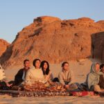Nathalie Kelley Instagram - An escape into the Sinai desert with our Bedouin brothers to dream of new JUST and JOYFUL futures with these climate justice warriors; amongst us singers, storytellers and policy makers. Earlier that week Youseff, a Bedouin man had told me how grateful he was that we were bringing the climate change conversation to Sinai. He told me that the Bedouins are also very aware that the world is now out of balance… he said even when they go to eat their traditional foods, like goats - they are now finding plastic inside. :( On this particular sunrise we imagined a post plastic and fossil fuel future - a world in which our more-than-human family (the animals, fungi, trees, mountains and waters) were seen as KIN. Thank you @lilycole for facilitating this potent meeting of minds and hearts. (Also loving your recent name change to Lily Solar Power!) And thank you @louisderohan for capturing the magic of these desert moments. #COP27