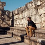Nathaniel Buzolic Instagram - John’s gospel chapter 6 - you will find Jesus speaking where I am pictured sitting. A synagogue that during Jesus’ day would have been some meters below this one But the same location none the less. Here Jesus will deliver the first of His famous “I am” statements. Jesus will say; I am the bread of life, Whoever comes to me will never be hungry & whoever believes in me will never be thirsty. The ancient Israelites in their wilderness wanders had to rely on God to provide manna (bread) & water. God Did. Note: They still had to collect it, but it was God who provided it for them. Jesus is making that parallel between the Jewish people of Old needing bread from God & the Jewish people of His time needing Him. The BREAD OF LIFE. Our essential daily need to just survive. Jesus will go on to say that everyone the Father gives him, will come to Him & ANYONE who comes to him he will NEVER reject. That’s the invitation. So if we know the invitation, what’s the promise? Jesus will say it FOUR times that whoever believe He is the Messiah they will be granted eternal life. And according to Jesus, He (himself) will raise them up ON THE LAST DAY. Jesus made two things very clear in this exchange with the religious critics. First - It will be He who raises up the dead. Meaning Jesus is claiming to have the power to give life. That’s a a God claim if God is the author of life. The second is this - He will do this on the last day. Let me repeat JESUS’ words so you catch it “ON THE LAST DAY”. So We will all fall asleep, Paul explains to the Thessalonians, kings like David would join their fathers who have fallen asleep before them. And it will be Jesus who raises them up from this SLEEP You see to the one who gives life, when we die, we are merely asleep to him. This means no heaven yet. You wait.. as we will all wait. Wait Until the messiah raises all men & women to face the reality of who God truly was & is. Don’t wait till this last day to know who God is. Seek Jesus now. Seek him with everything you have because nothing will matter more on that day then knowing God in spirit and truth. Eternal life is only for the one who believes in this temporary life.