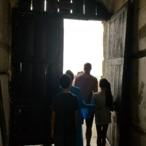 Nicole Ari Parker Instagram - Today my heart pounded as I stood in front of one of the two small windows...the only shaft of light..the only brief gust of wind inside the small female dungeon at #CapeCoastCastle. The spot that hundreds of shackled women surrounded by their dying sisters and children were forced in desperation to fight for... beg for..die for. 
A brief moment in the sun. 
A long visit to #CapeCoastCastle and #ElminaCastle was what I needed Sophie and Nicolas to experience. To see. To listen. To understand.
They are two of the last remaining sites along the GoldCoast that bear witness to over 300 years of the brutality and horrors of the slave trade. 
We saw the powerful Nkyinkyim  installation by artist Kwame Akoto-Bamfo depicting in terracotta the faces of people enslaved here.
We walked thru the Door of No Return, following the path our ancestors took as they boarded ships.
Then our guide #MrBlankson turned us around and we went back thru the same door...symbolizing our return.
 When we arrived at #ElminaCastle and Sophie saw the tiny door she had only read about..We stood in silence and then we prayed. 🇬🇭 Namanom yɛ hyɛ him ɛnyimnyam, yɛ da hom ase dɛ homdze bin aba fie.🇬🇭
Ancestors we honor you. We thank you for bringing us home.