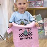 Nicole Franzel Instagram - Arrow came to work with me today (no surprise there 🤪) he loves to work and LOVES when he gets customers so he wanted to make a video! ☺️ When he packs them he makes sure to give you a sticker or two that he personally picks out btw 🥰 ps Evie is his cousin. Or “ebie” as he says lol. New shirts are in!! 🐥 there are THREE woman owned small businesses’ hand in making these. Local customers can do free pickup if wanted! Ps if you spend $75 on the site it’s free shipping! Otherwise a flat rate of $7 is shipping costs!! 🩷 🐥 🐰 SHOP LINK IN BIO 🐰 🐥