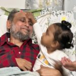 Nusrat Imroz Tisha Instagram - ২৯ তারিখে মোস্তফা সরয়ার ফারুকীর একটা সিটিস্ক্যান হয়েছে। আলহামদুলিল্লাহ সিটিস্ক্যানের রিপোর্ট ভালো এসেছে ,রিকভারি হচ্ছে। বাসায় নিয়ে আসার পরপরই ইলহামের সাথে খেলায় মজে গেছে মোস্তফা। অনেক দুর্বলতার মাঝেও সন্তানের প্রত্যেকটা খেলায় সায় দেওয়ার চেষ্টা করছে সে। বাবা মেয়ের এই ভালোবাসার ছবি না তুলে আর থাকতে পারলাম না ।আলহামদুলিল্লাহ। সবাই দোয়া করবেন। #tisha #nusrtaimrosetisha #imrose #mostofasarwarfarooki #ilhamnusratfarooki #familytime #prayforus