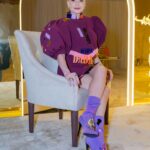 Pamela El Kik Instagram – من لحظة ما وصلت على مطار #الرياض #السعودية لأيّ مكان تواجدت في، انغمرت بِحُبّ شعبو والبسمة الحقيقية وحسن الضيّافة اللي ما إلا وصف👑
ممنونة ومشكورة لكل نقط الحُب 🇸🇦
#أنا_عربية 
•••

I decided to support a young talent from my country by wearing a full look from Nour Takieddine’s D2D collection.

•A collection inspired by the Dada art movement, created as a reaction to the violence and absurdity of world war 1.
In such hard times, I believe in the power of art as a great way to express our emotions, and rebel against the way our world functions today.

•Nour Takieddine’s collection was a perfect fit for my way of thinking, and I really wanted to wear this look tonight that consists of an extravagant jacket, with a fully hand embroidered back illustration of Emmy Hennings. 
I saw a part of me in this woman, and that was an extra reason for me to pick this specific look. 

•Hennings was a bold artist, poet, and performer who fought so much for her thoughts and questioned a lot the societal norms. All the handwork on the back of this jacket started from a one line drawing technique done by Nour, representing an autoportrait of Emmy. 

•The look also consists of an asymmetric skirt that has a deconstructed waistline, and a curvy hem another way to rebel against what we think is ‘normal’, the outfit is embellished with plexy laser cut elements representing words and geometric shapes referencing Dadaist paintings and exploring new materials that are considered odd or weird  applied on fabric.

• to complete the look with these special heels with hand embroidered abstract faces inspired by DaDa collages and plexy embellishments ✨
@n.tbynour 🧡