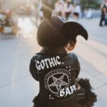 Rebecca Victoria Hardy Instagram - Dark paradise 🖤🦇🕸️ Ears: @batsday Jacket: @blackcraftcult #disneyland #gothicbaby #batsday #alt #goth #mommyandme